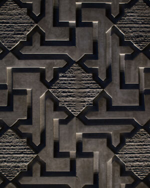 Monolith cube with labyrinth pattern floating above concrete floor